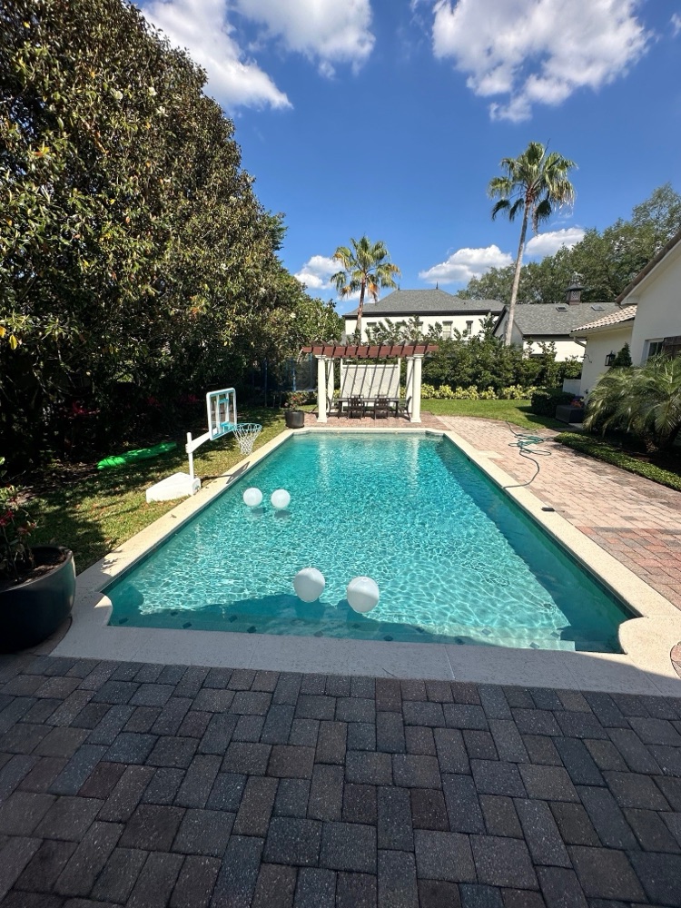 Brick patio to travertine deck + raised spa — before, view 2