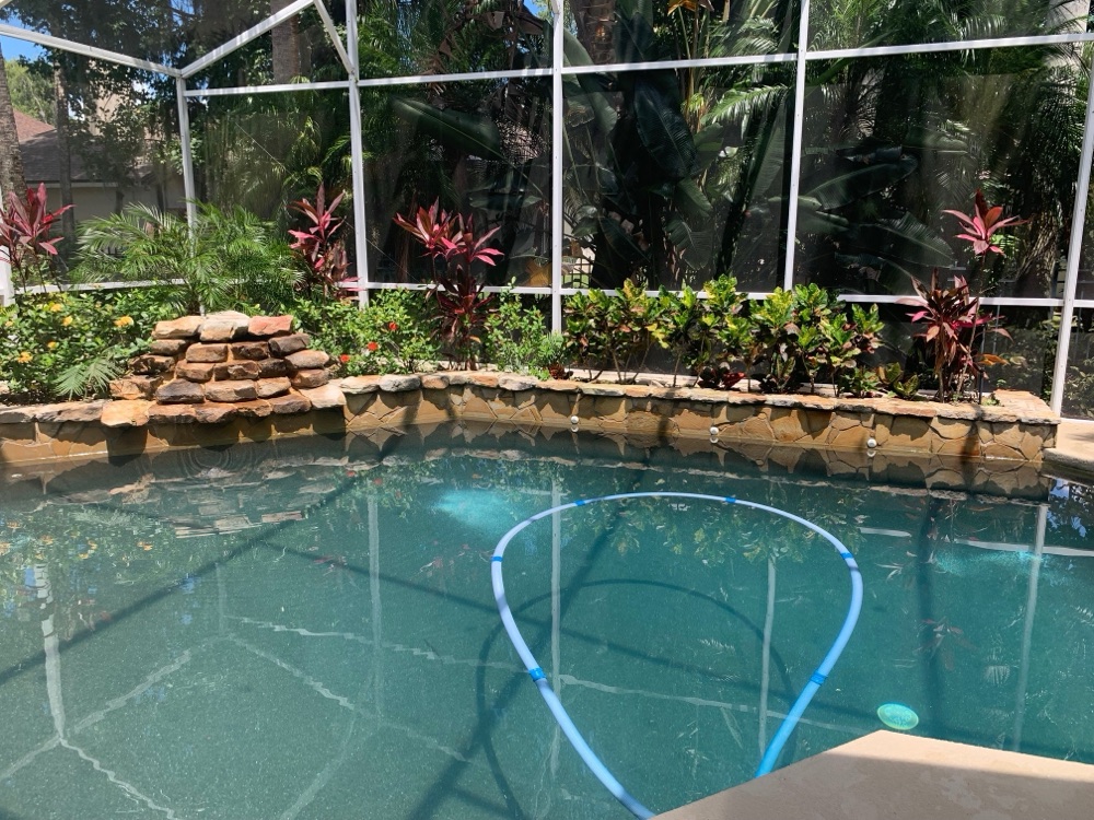 Rock waterfall to scupper wall + loungers — before, view 1