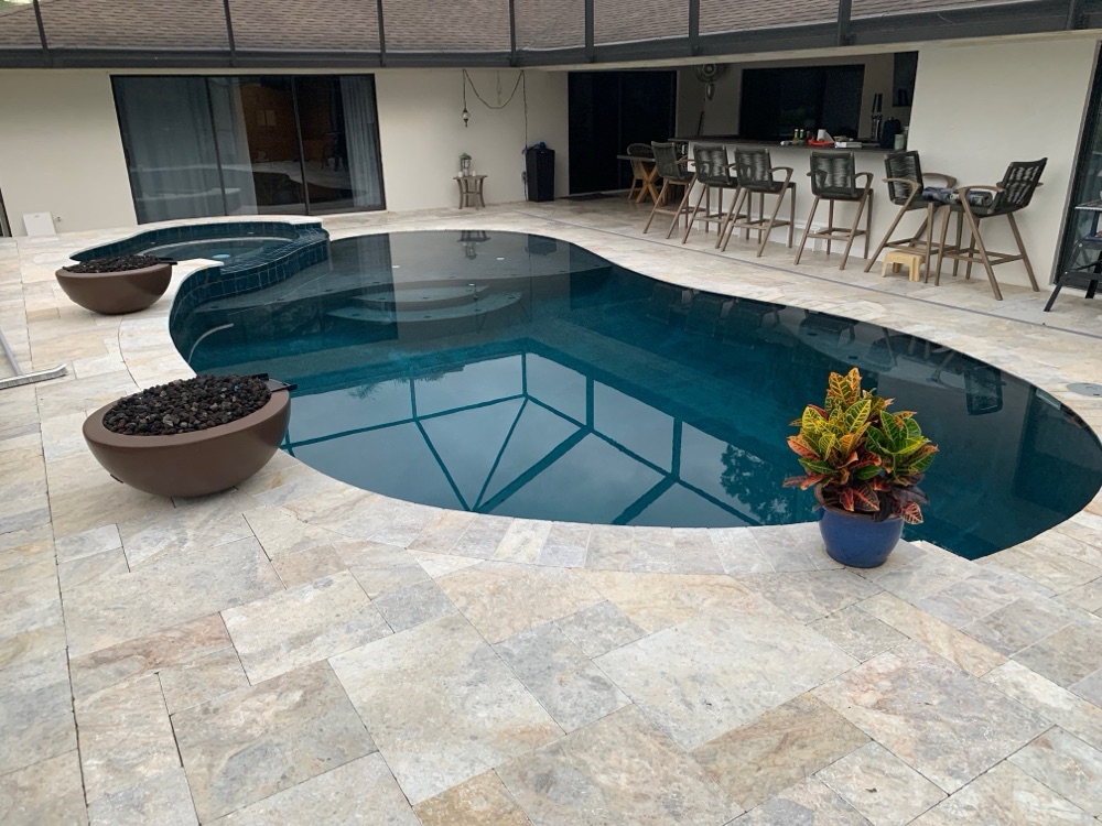 Lakefront resurface + travertine deck + fire bowls — after, view 2