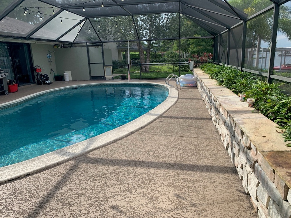 Lakefront resurface + travertine deck + fire bowls — before, view 2