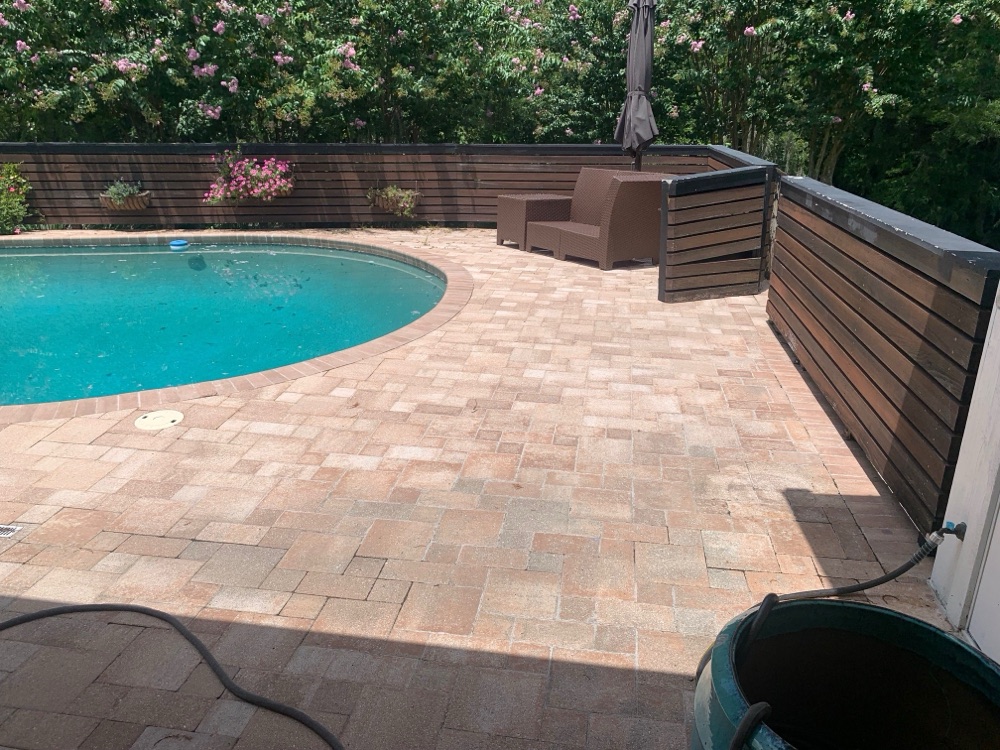 Brick coping to dark resurface + travertine deck — before, view 2