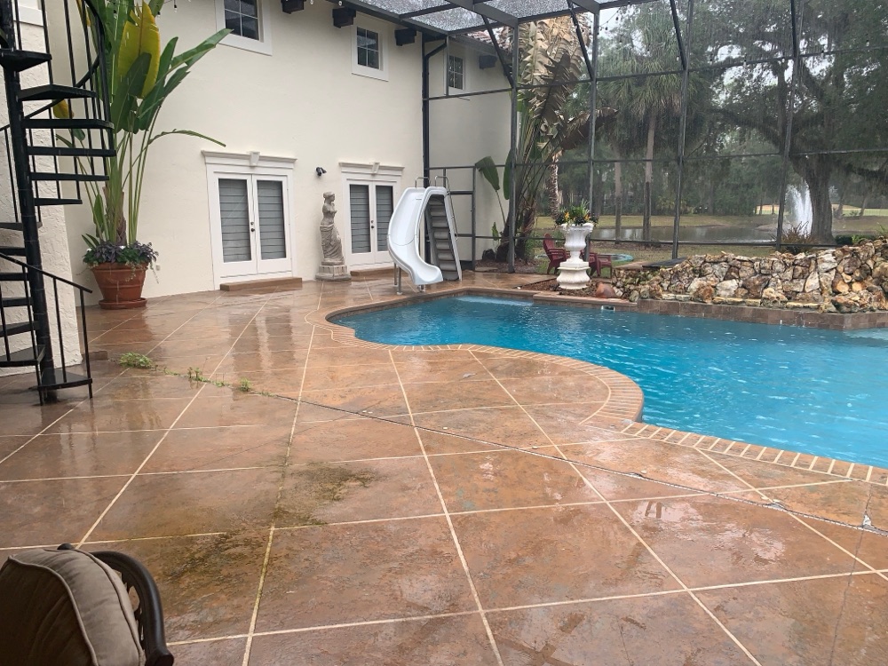 Rock waterfall to pebble sun shelf + loungers — before, view 2